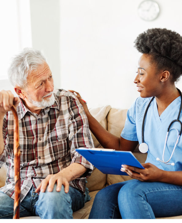 black caregiver woman talking to a senior man